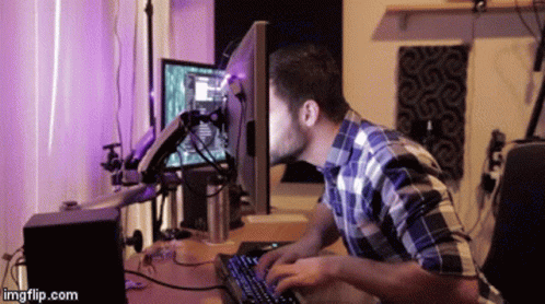 A GIF of a person typing on a keyboard with their head seemingly in a computer screen.
